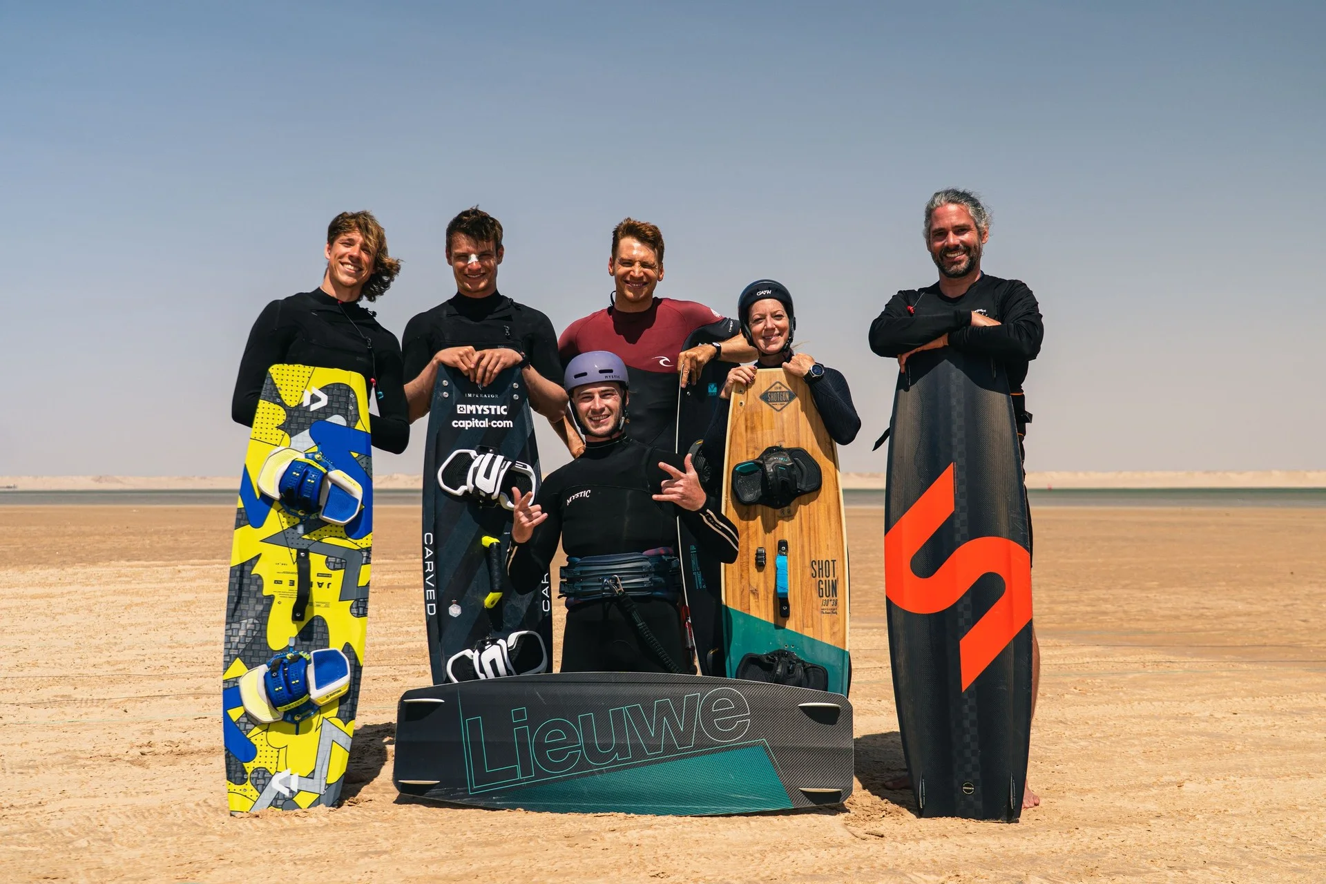 DC coaching trip participants with kiteboards on the beach